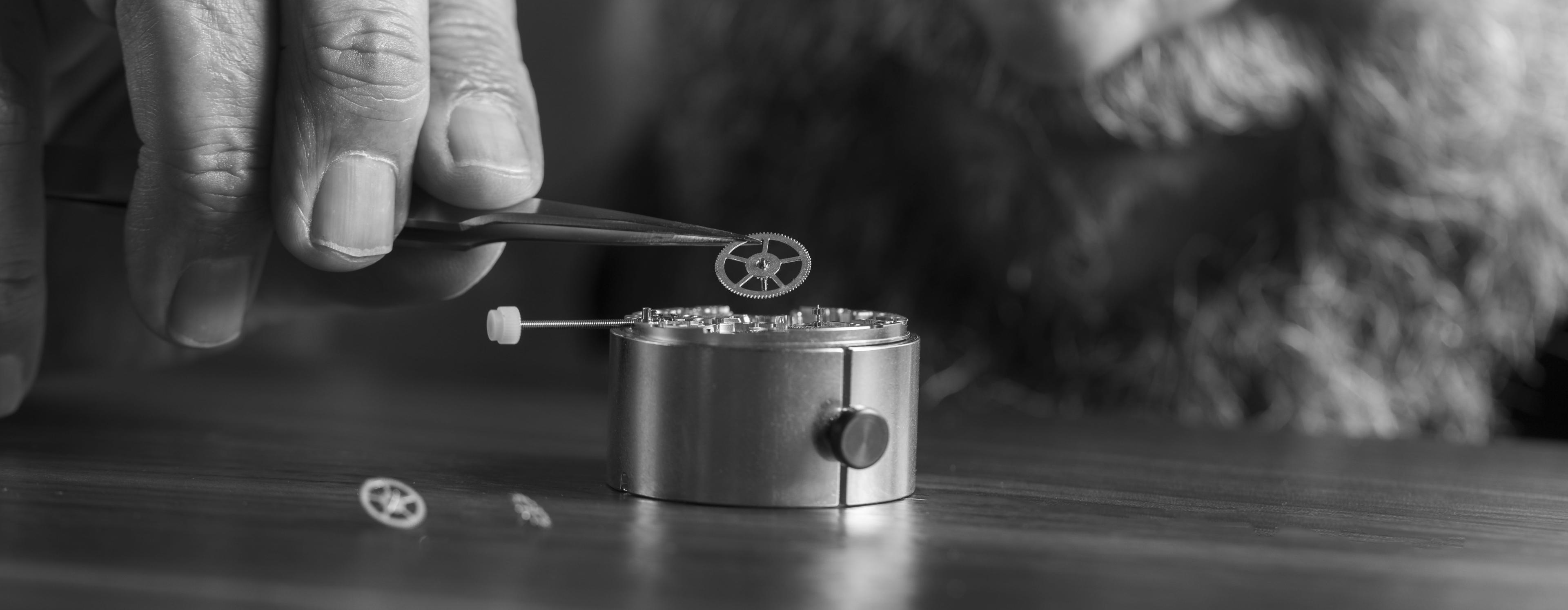 A man assembling watch parts